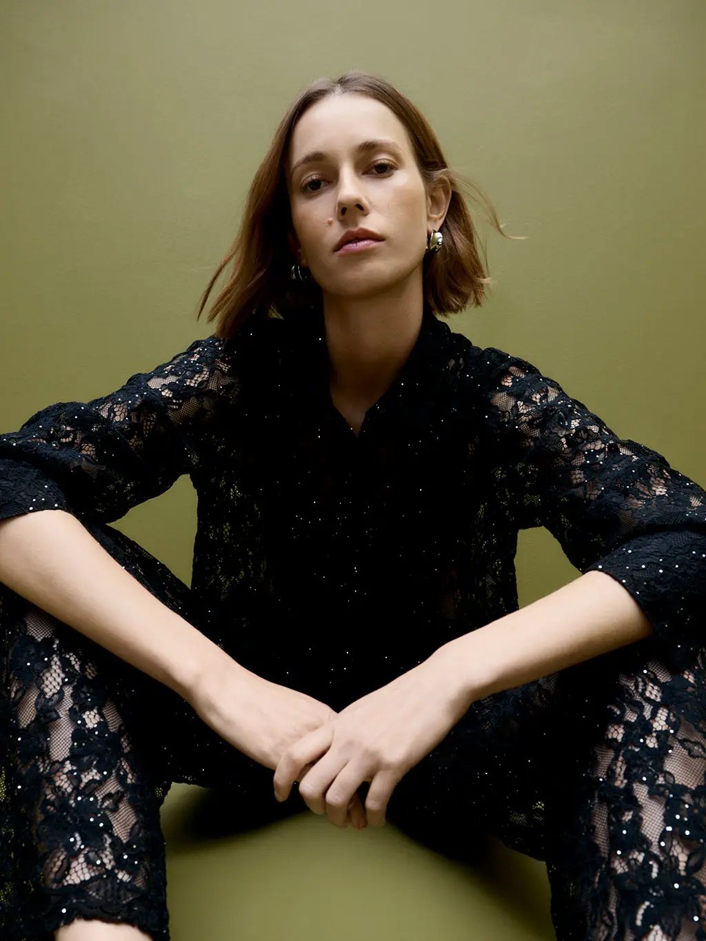 Woman wearing a lace shirt and trousers