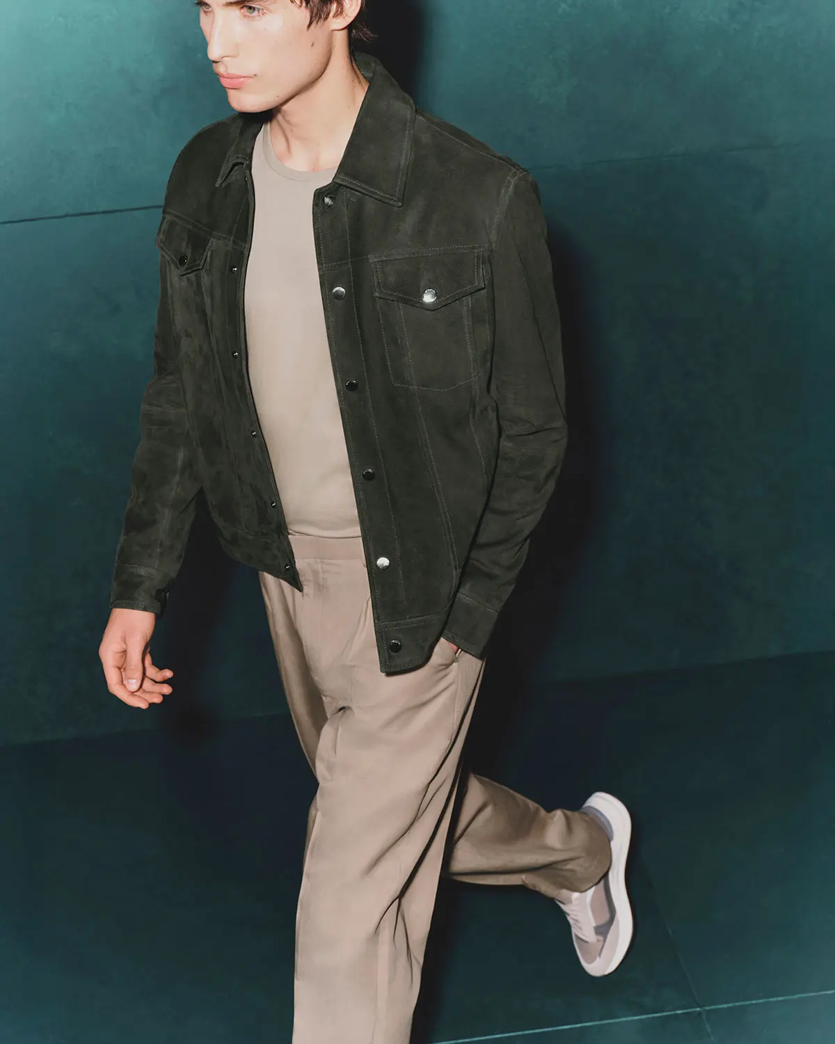 Man wearing olive green jacket and sand trousers