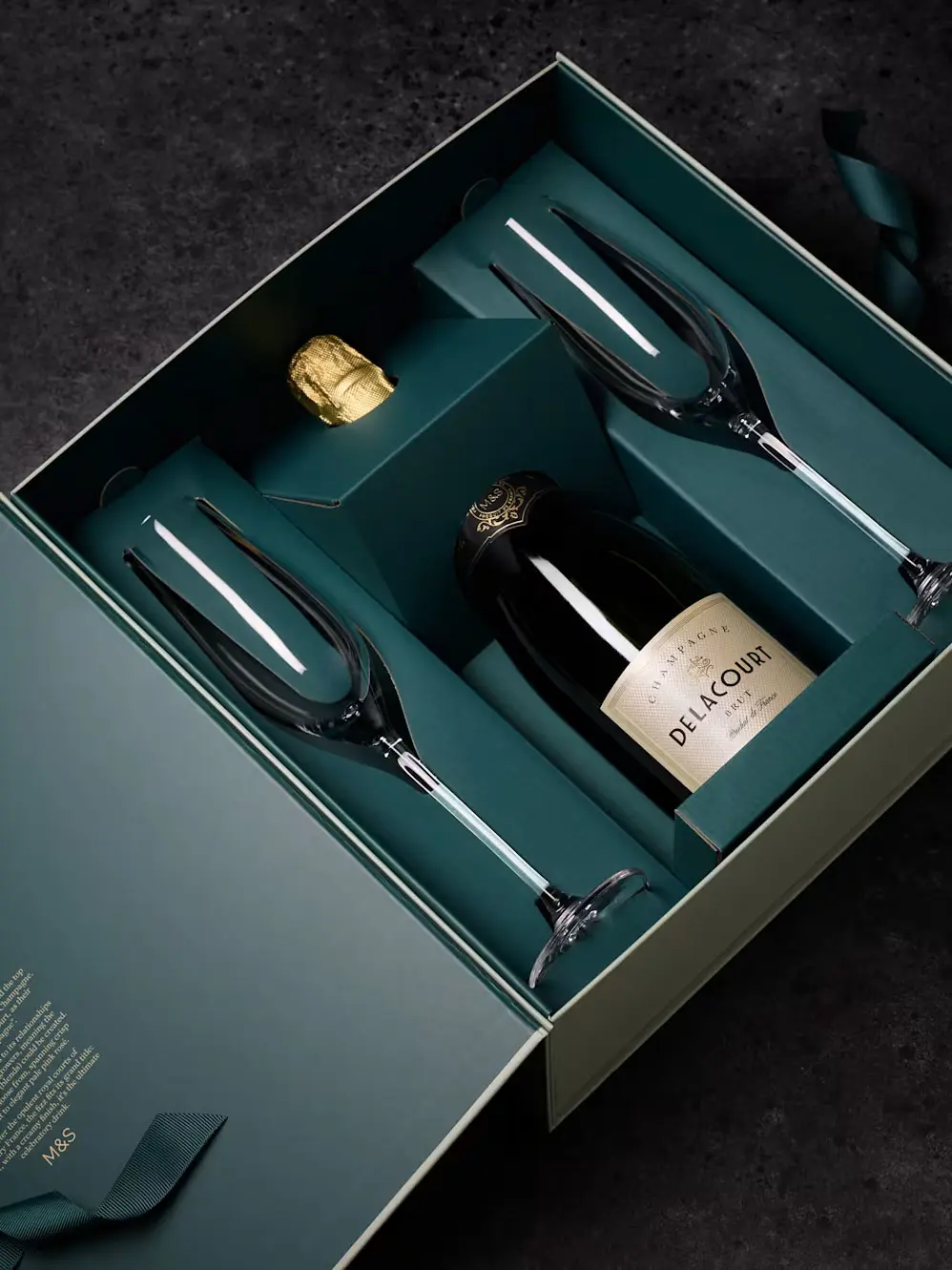 Bottle of Delacourt Champagne and glasses