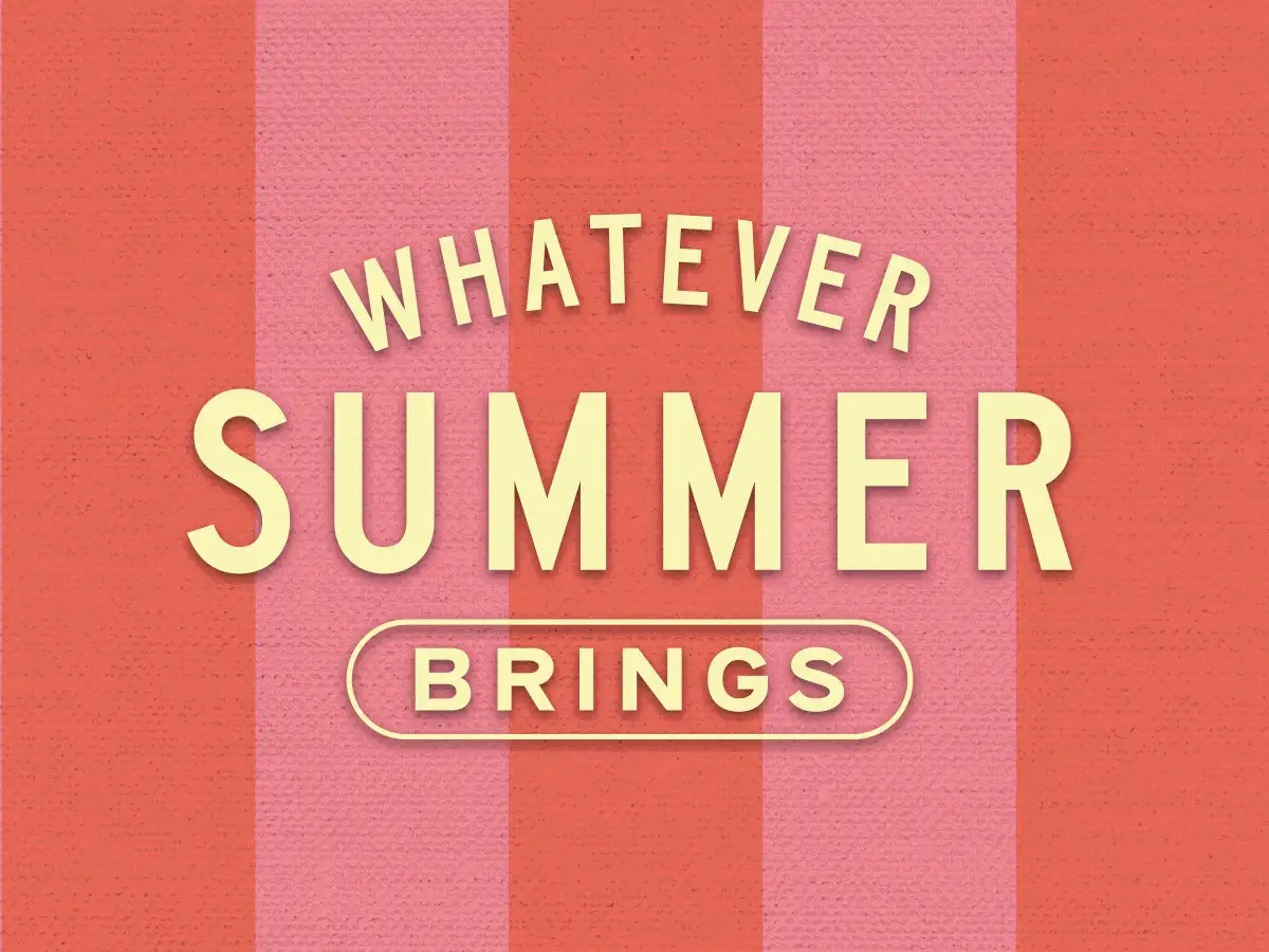 A thick-cut steak on a barbecue with tomatoes and garlic.