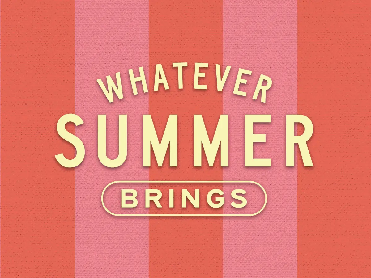 A thick-cut steak on a barbecue with tomatoes and garlic.