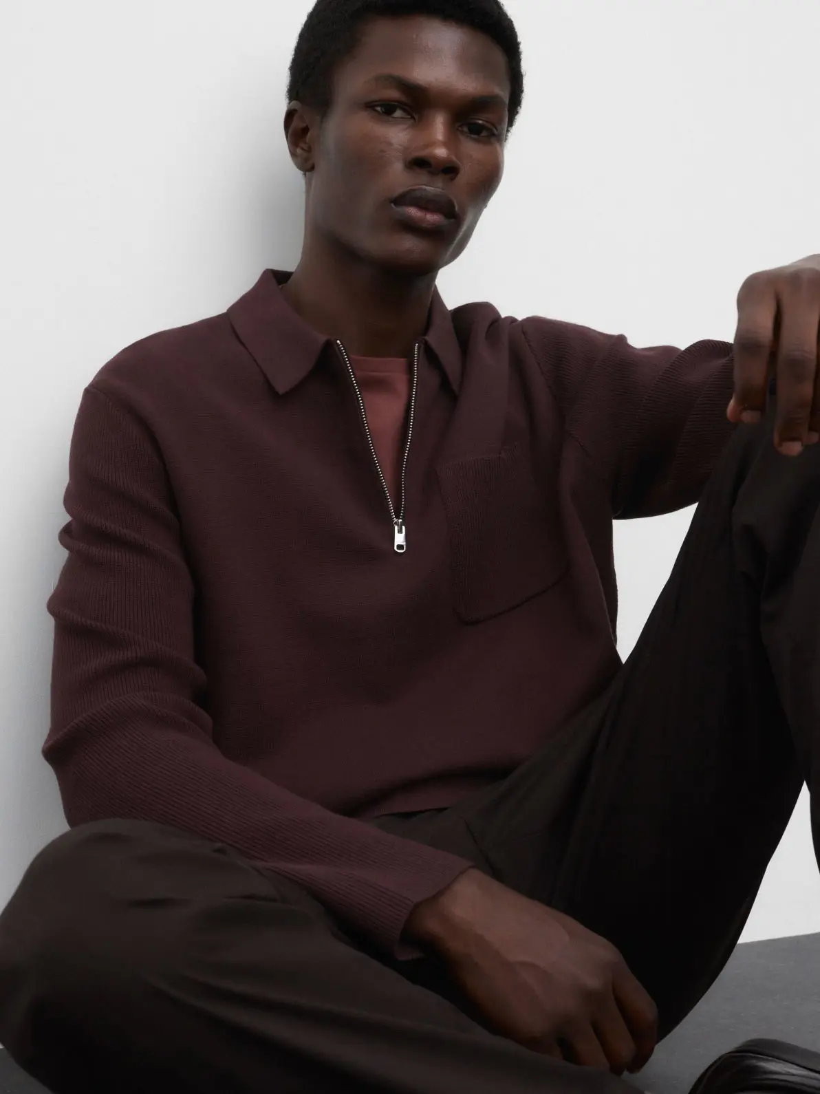 Man wearing burgundy polo jumper