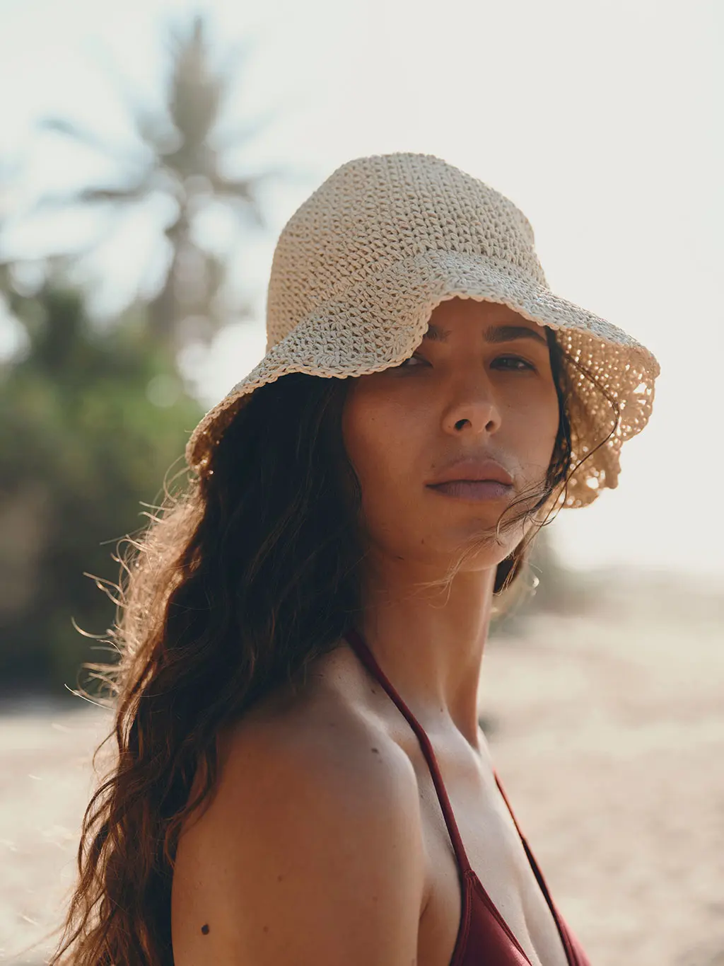 Woman in knit hat on beach