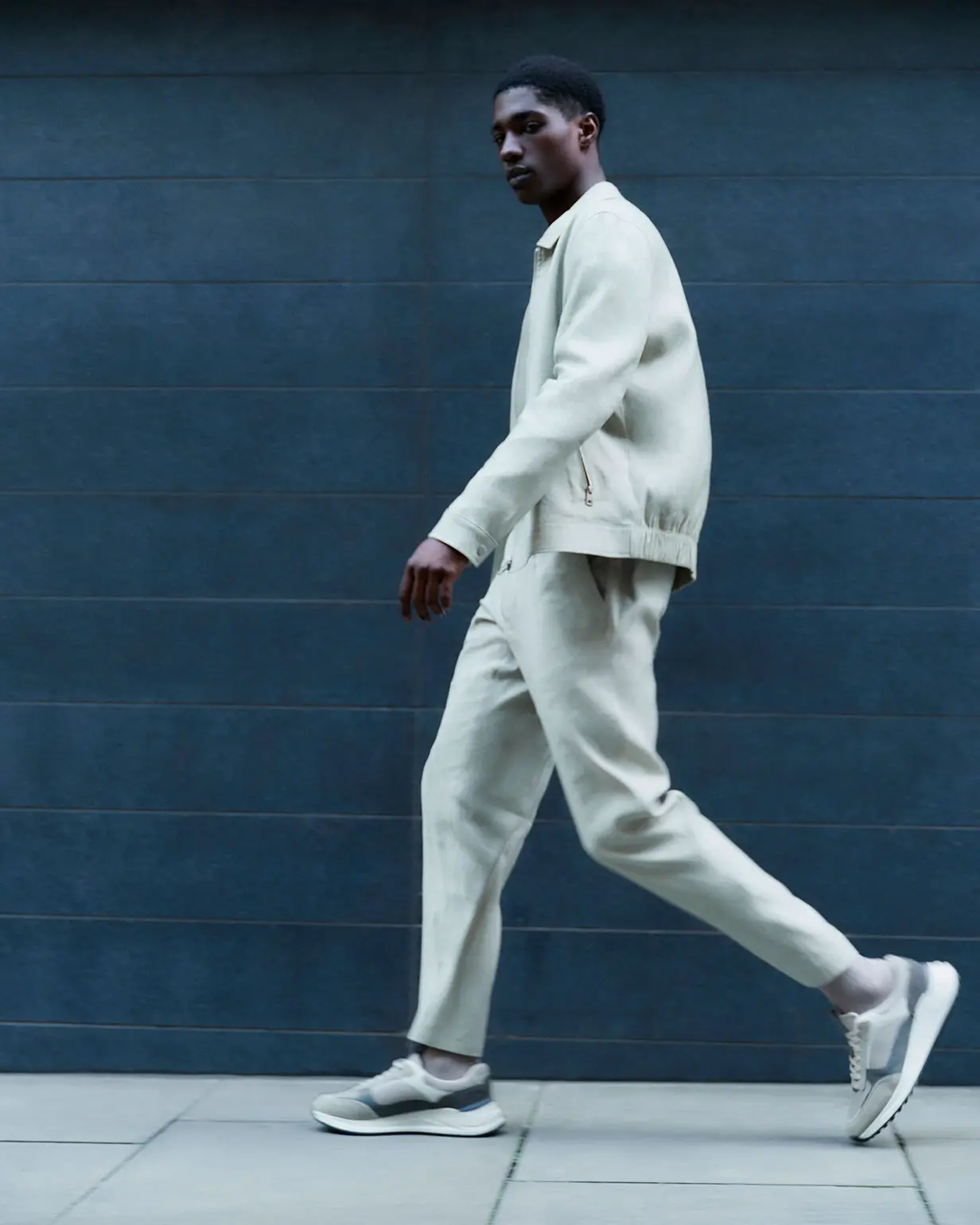 Man wearing cream linen  Harrington jacket and matching trousers