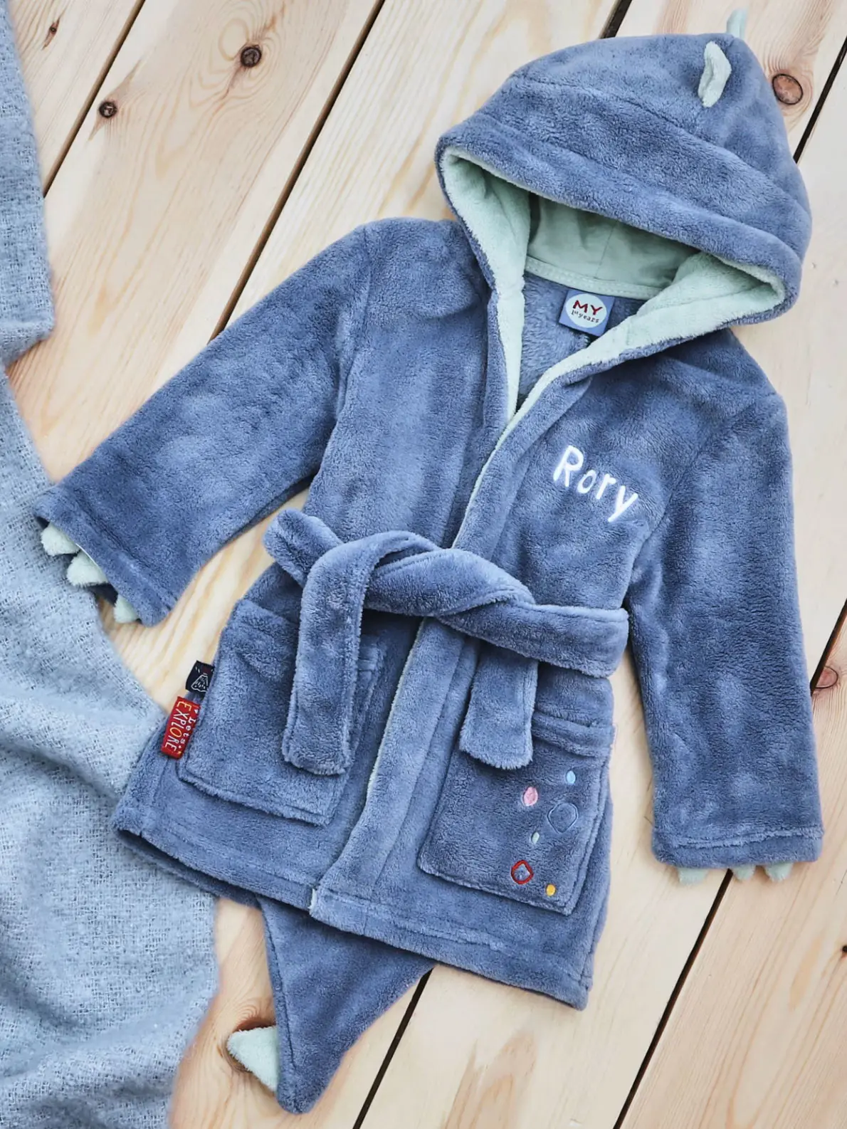 Blue children's robe with two pockets and the name 'Rory' embroidered
