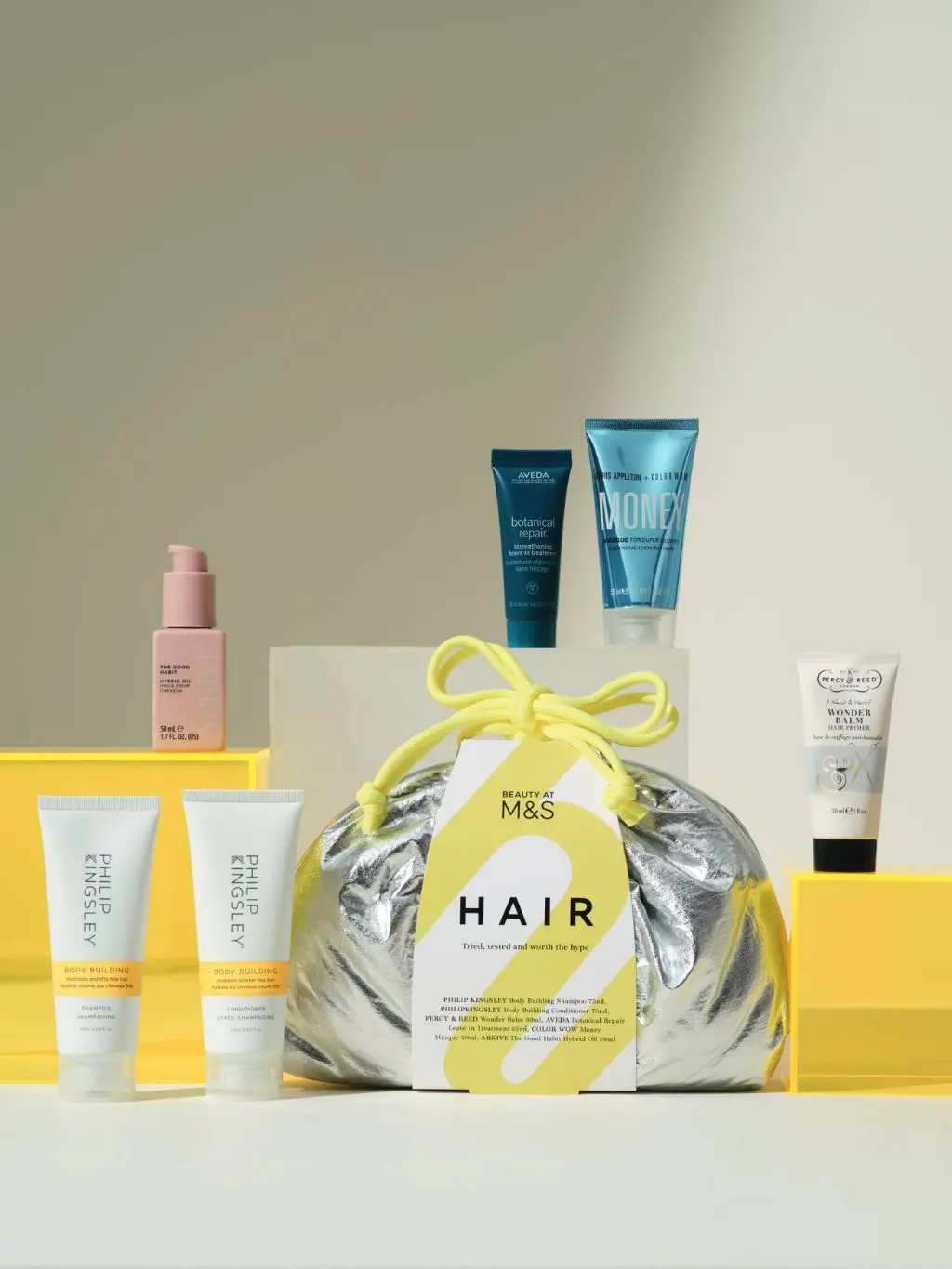 A metallic M&S bag containing hair products