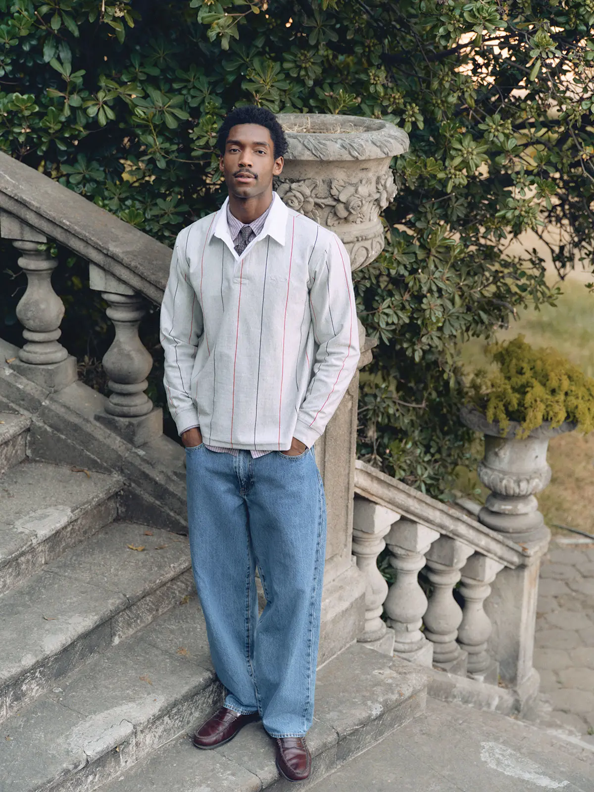 Man wearing shirt, blue Levi's jeans and loafers