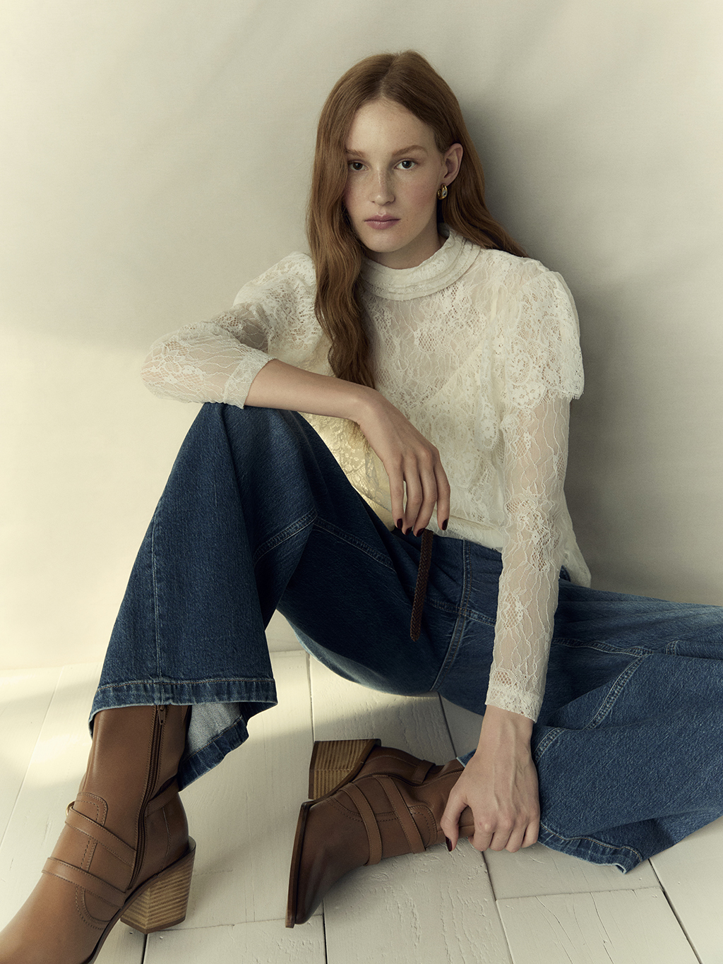 Woman wearing Per Una lace blouse and wide-leg jeans