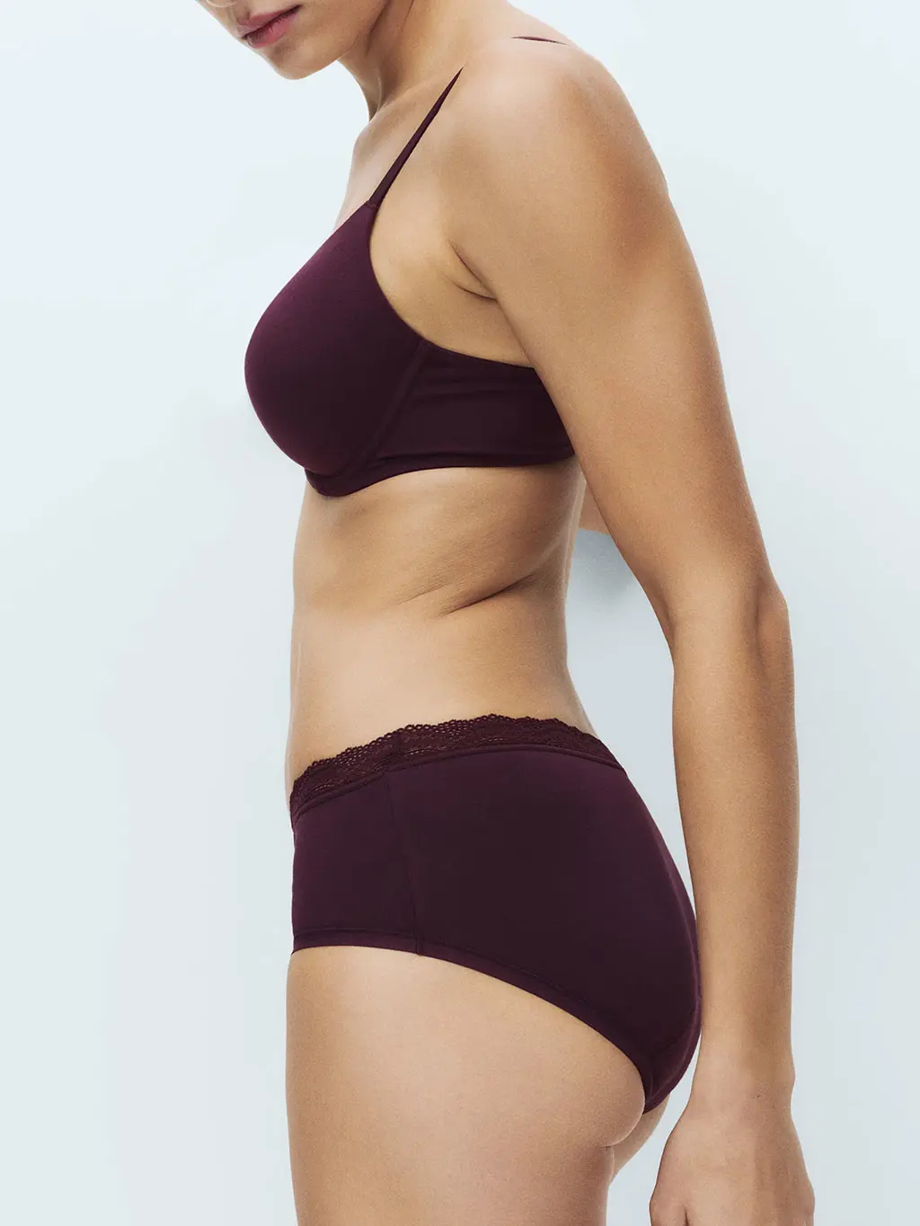 Woman wearing red heavy absorbency period pants