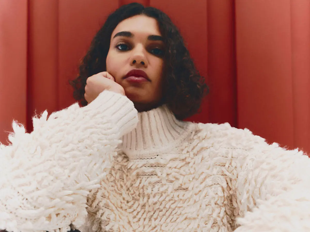 Woman wearing cream fluffy jumper