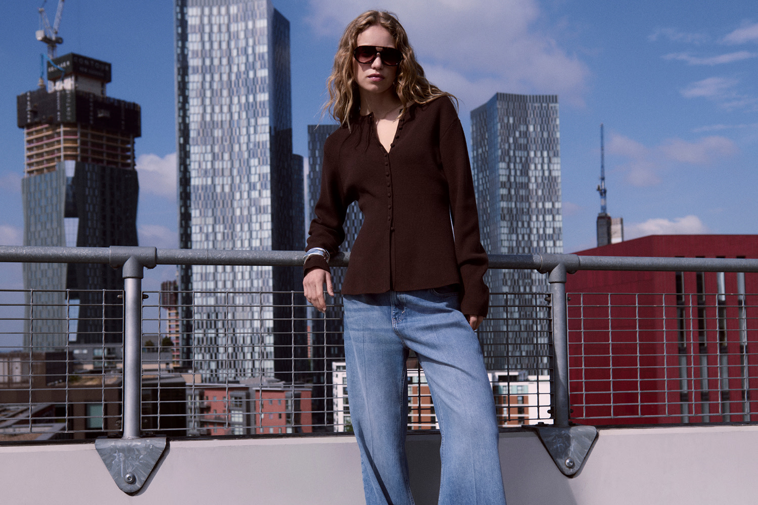 Woman wearing a black blazer and wide-leg jeans