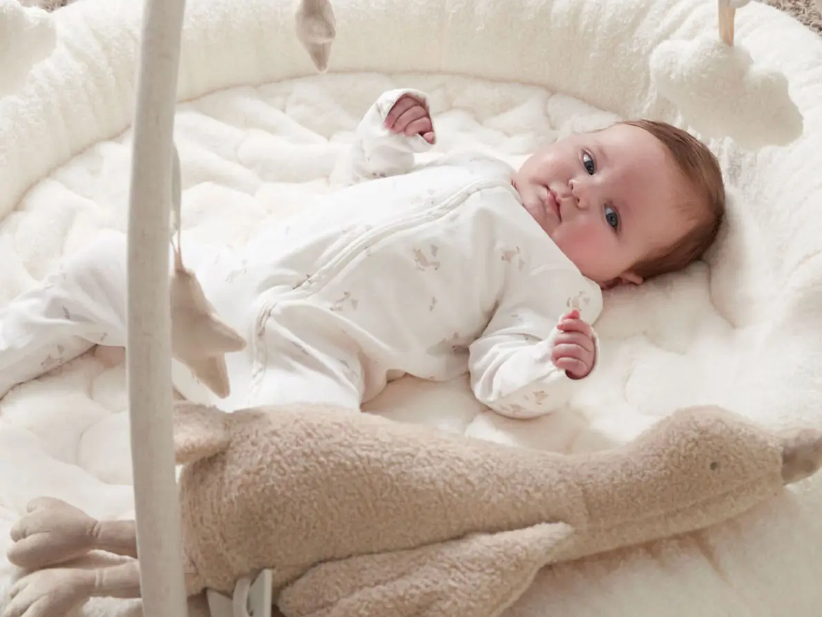 Baby lying on a playmat