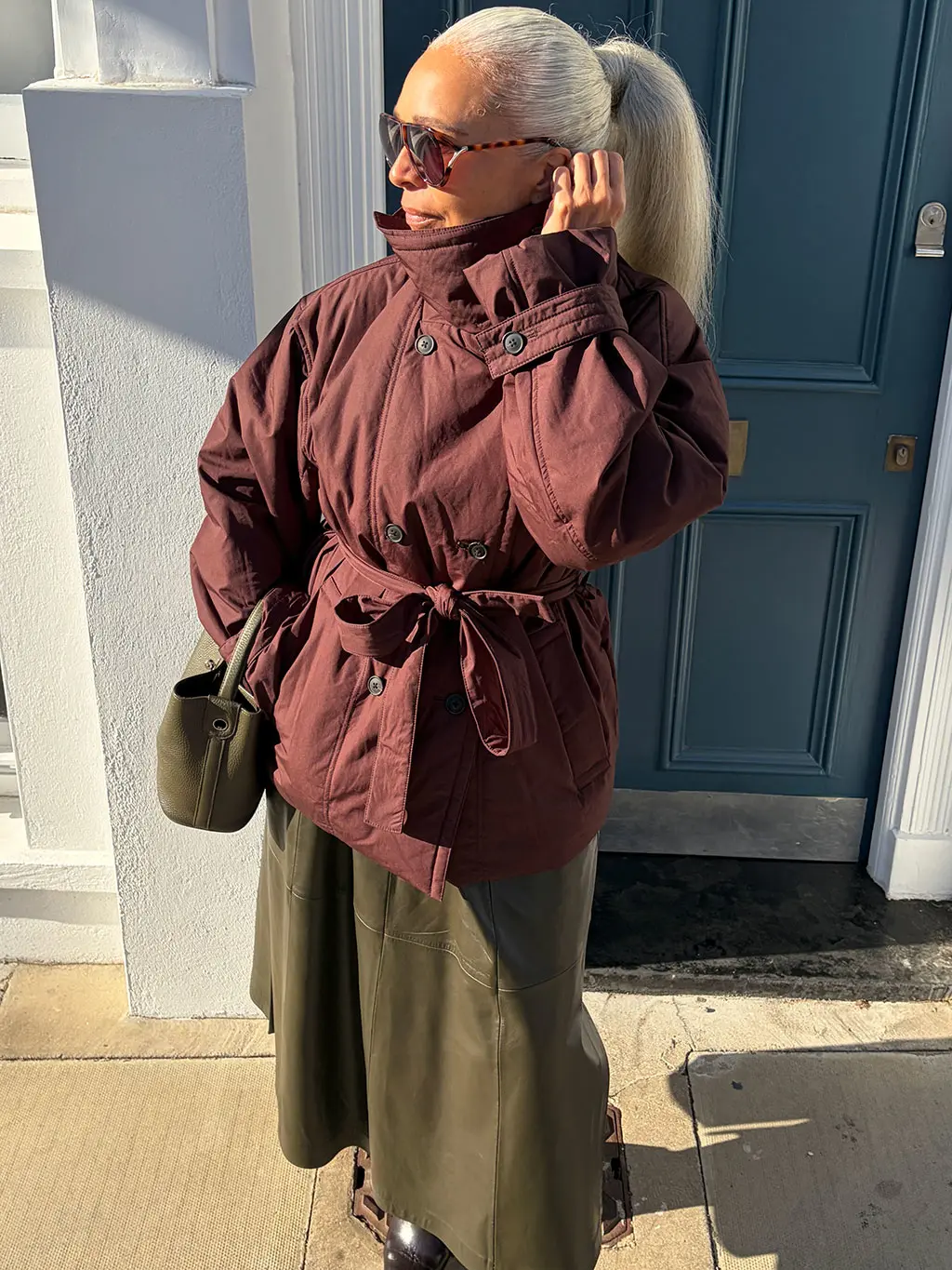 Mia Maugé in burgundy coat