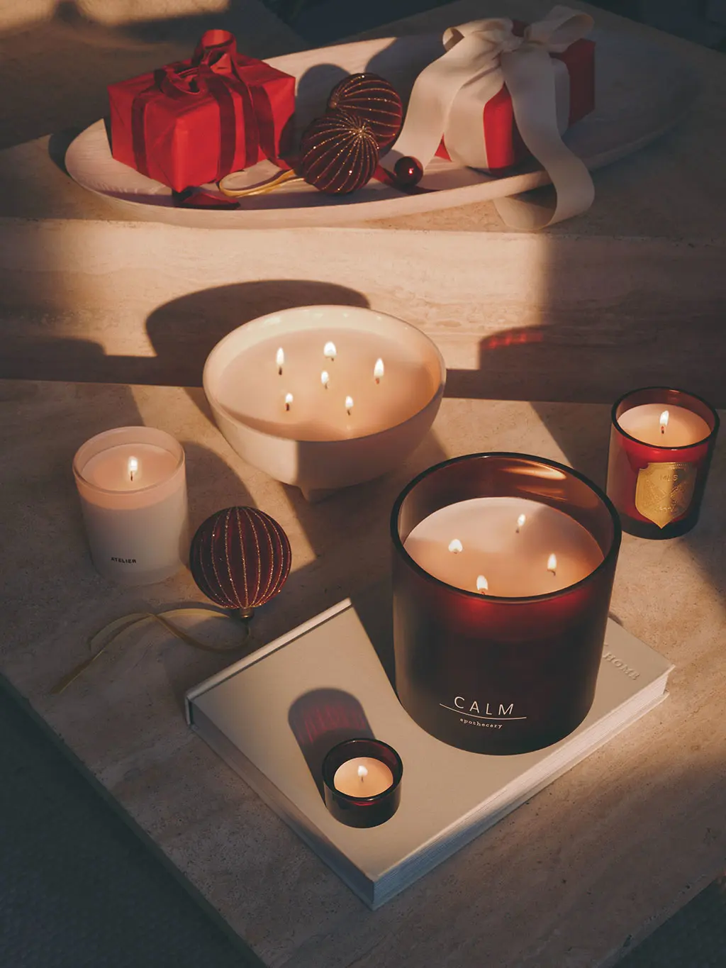 Group of three and single wick candles in white and red votives.
