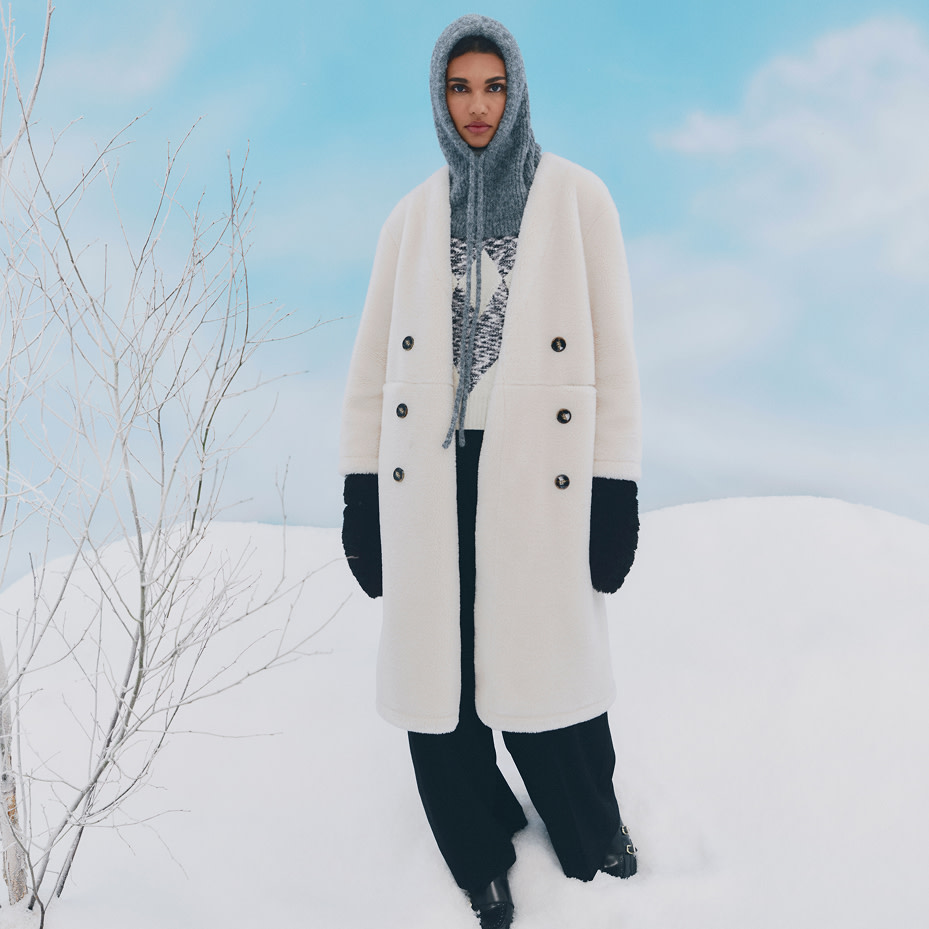 Woman wearing grey balaclava and a cream coat