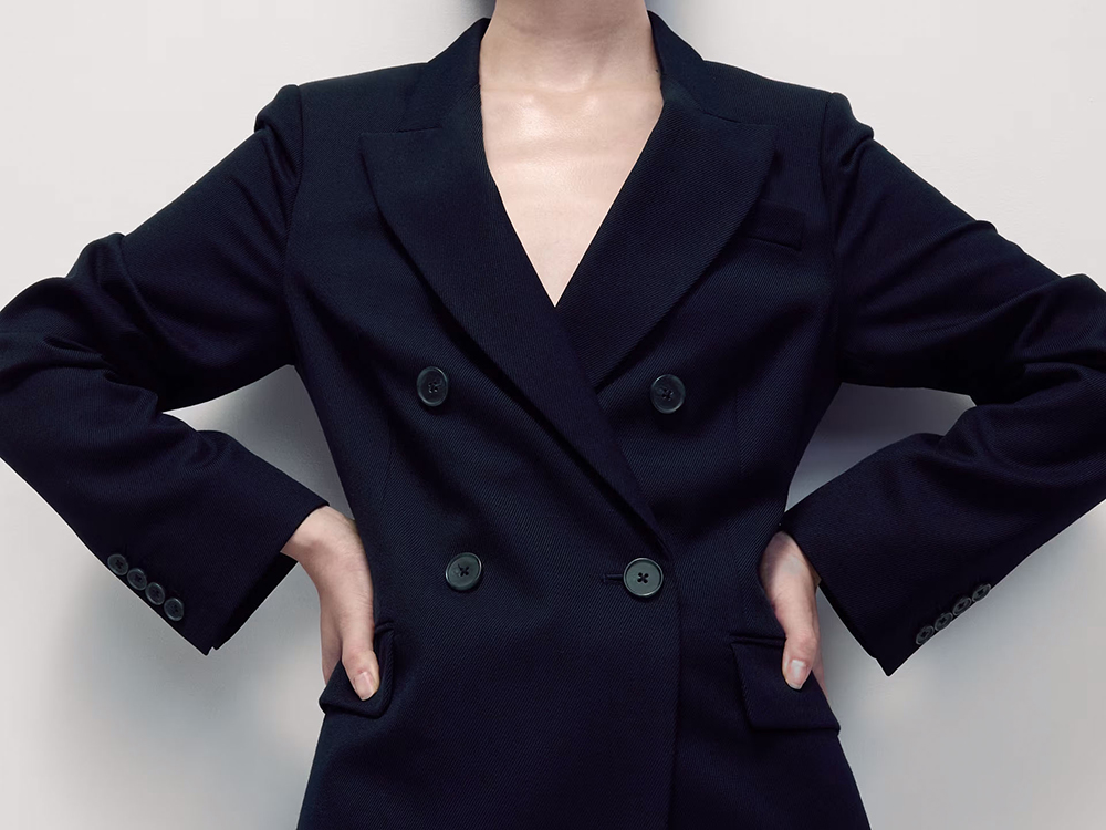 Close-up of woman wearing navy double-breasted blazer