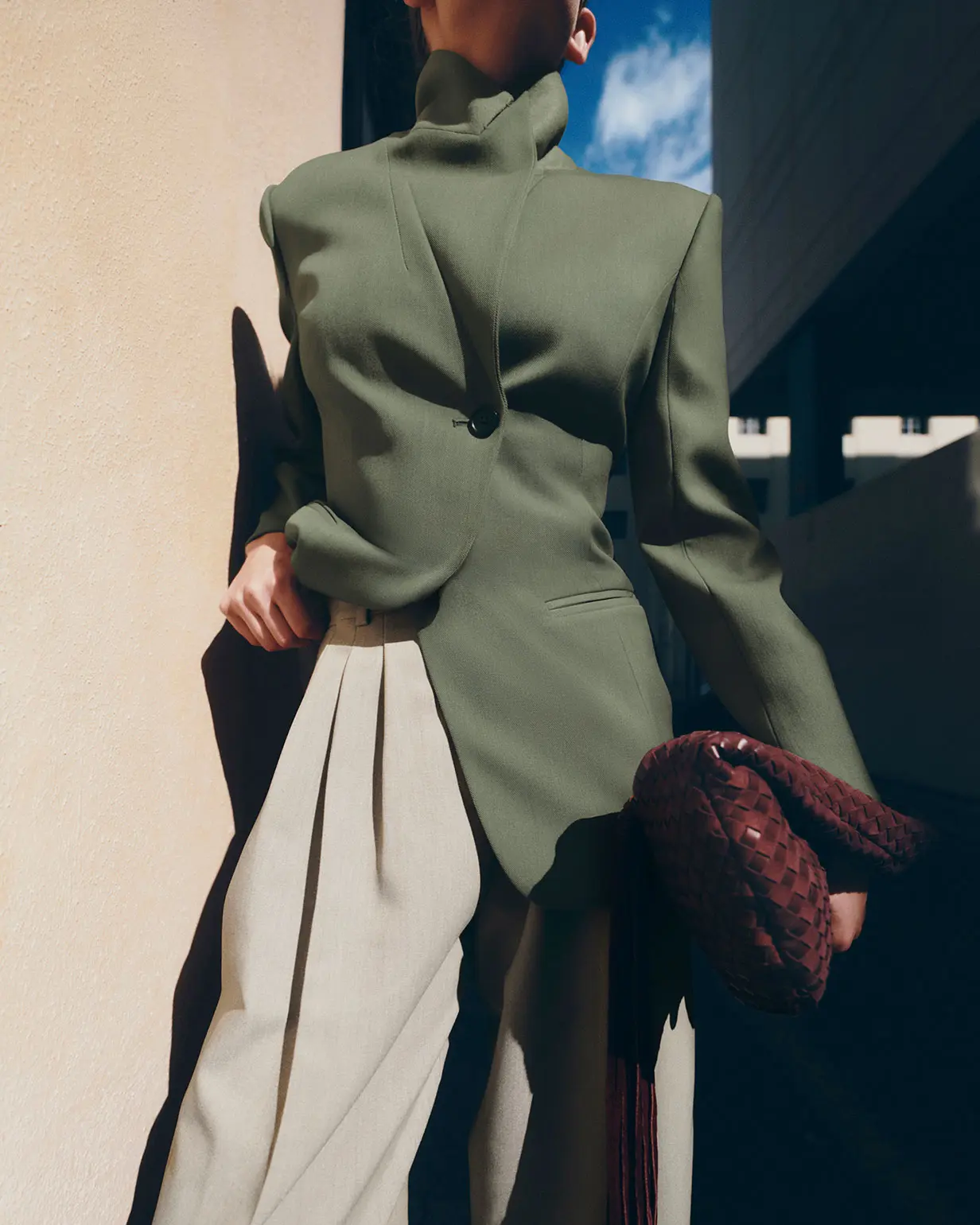 Woman wearing green asymmetric blazer