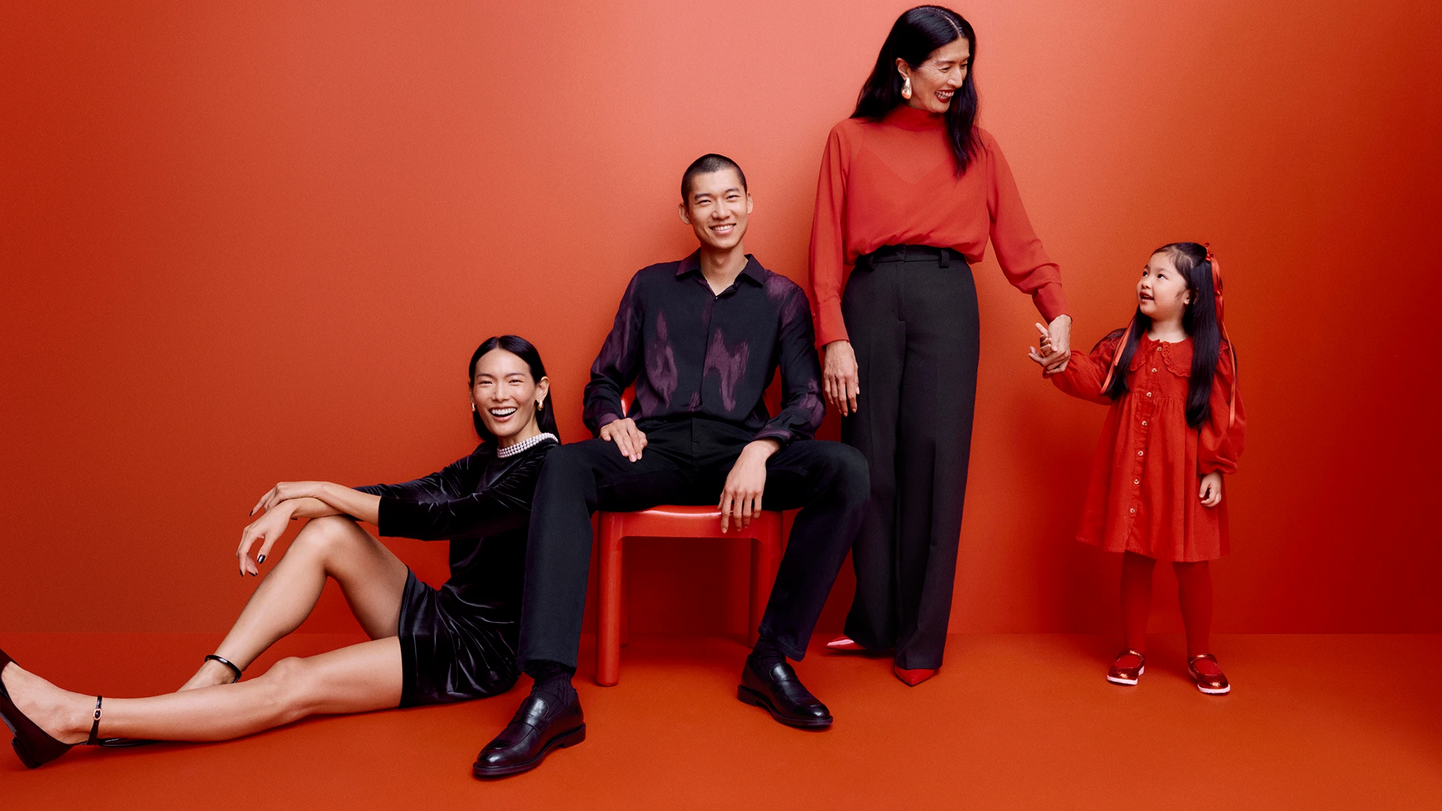 Family wearing red and black outfits to celebrate Lunar New Year 2025