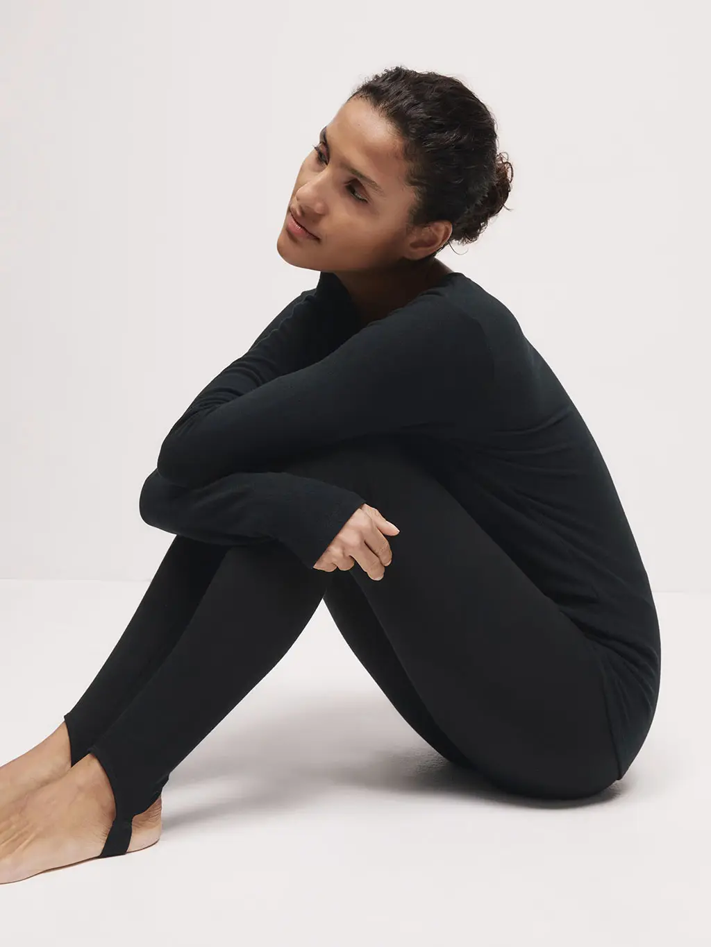 Woman wearing a thermal top with thermal stirrup leggings