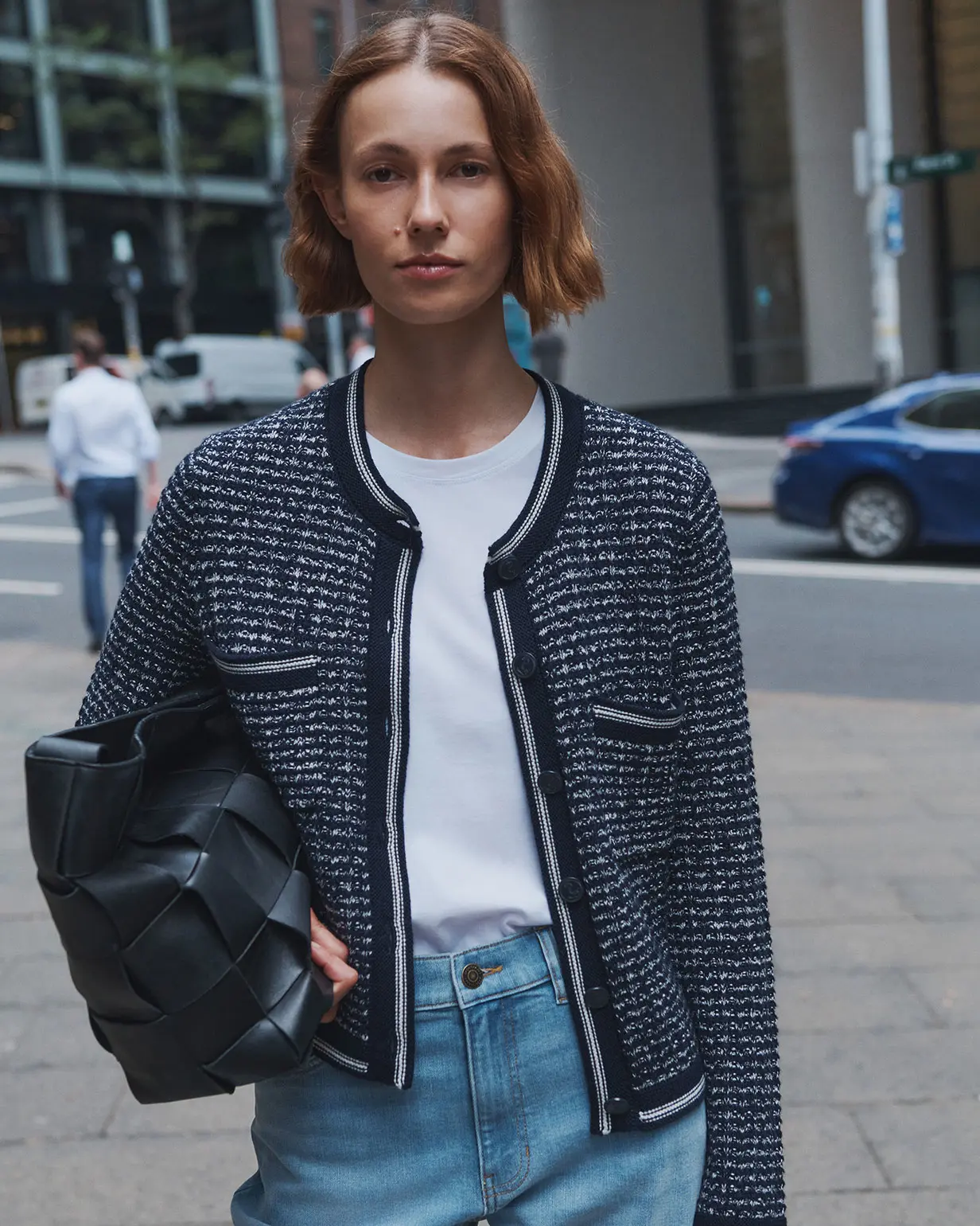 Woman wearing cropped jacket, white T-shirt and jeans by Sportscraft