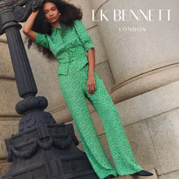 Woman wearing green two-piece top and trousers. Shop LK Bennett