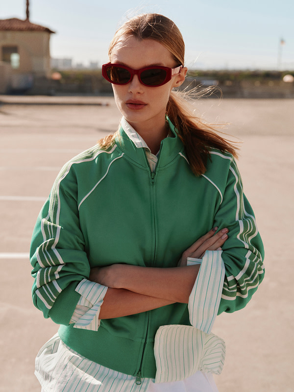 Woman in green track jacket