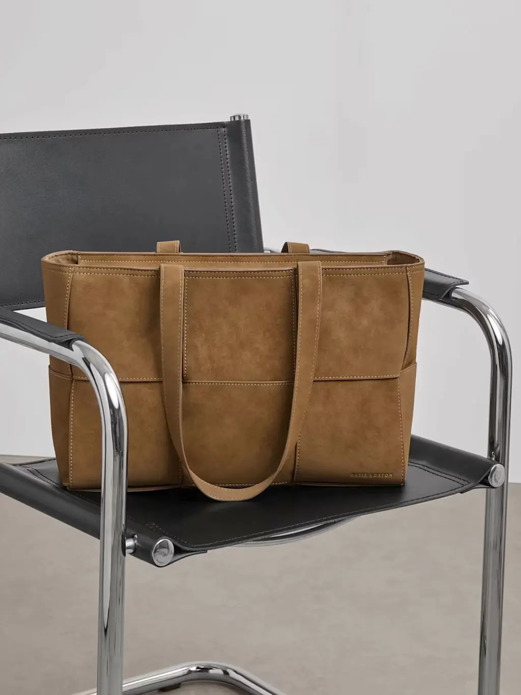 Personalised tote bag on a black leather arm chair