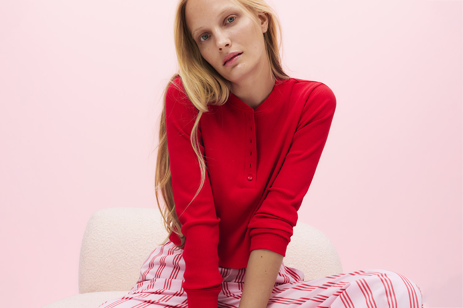 Woman wearing red cotton rich pyjamas with long sleeve