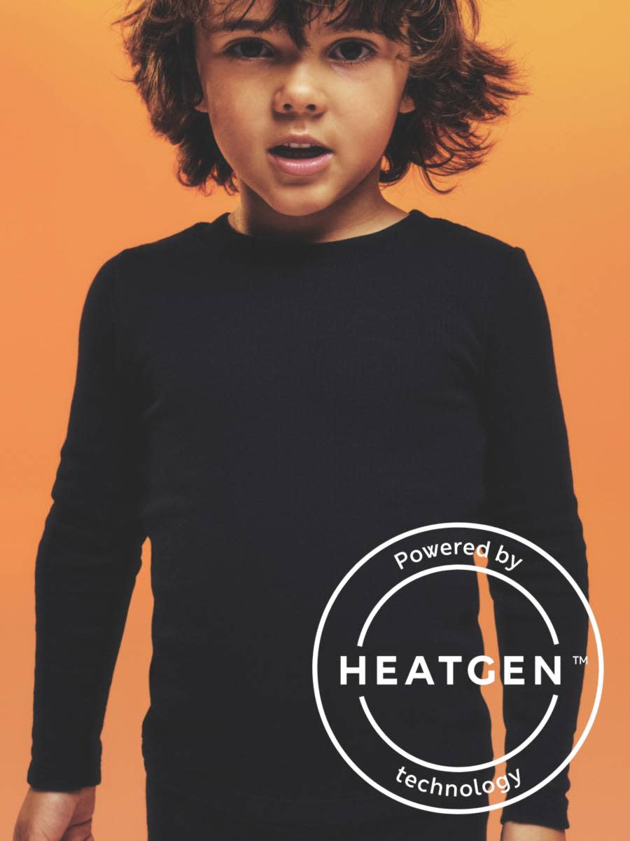 Young boy wearing long sleeved black thermal t shirt