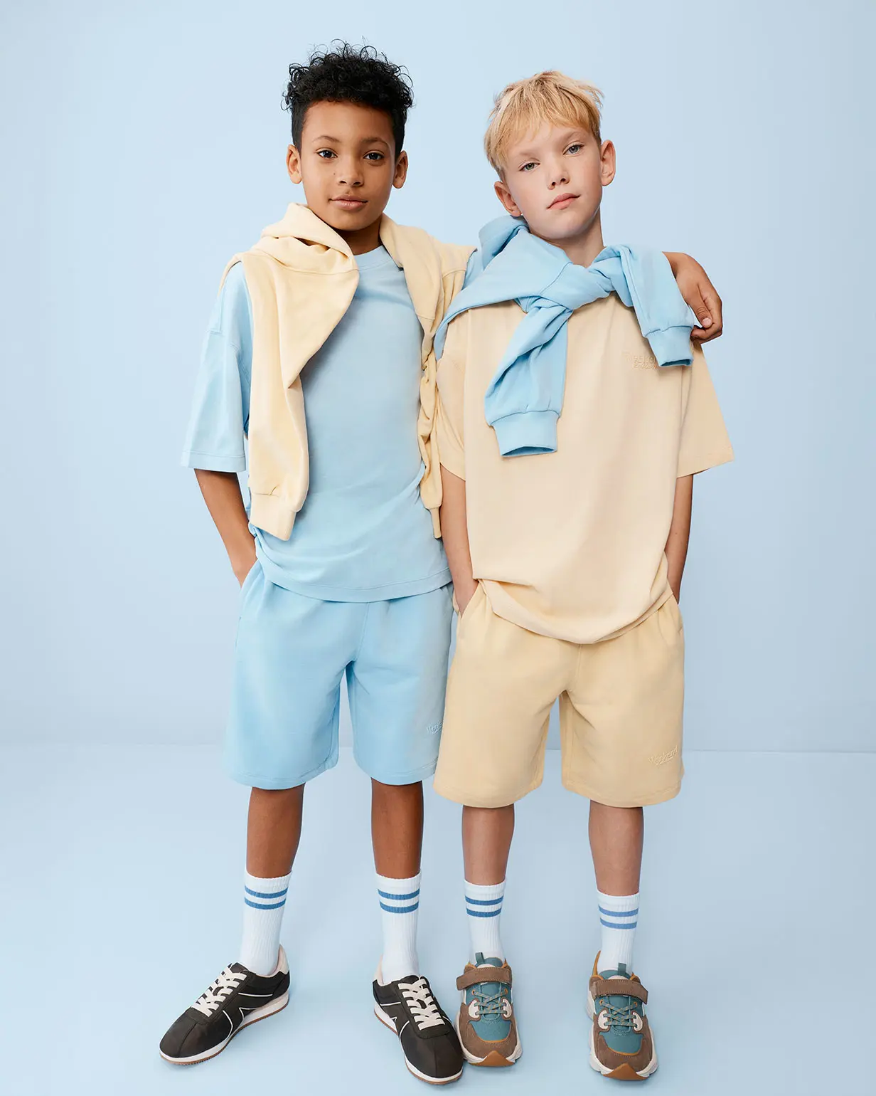 Two boys wearing T-shirts and shorts