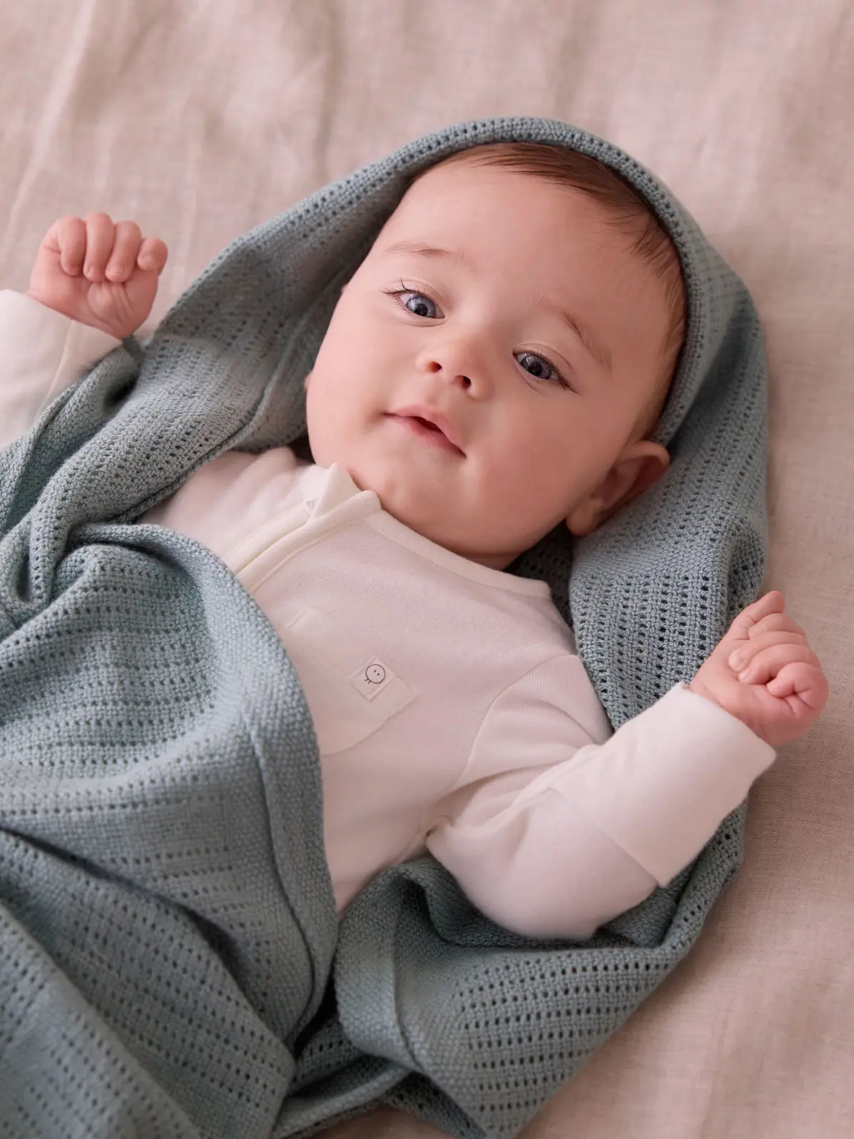 Baby wrapped in blue blanket