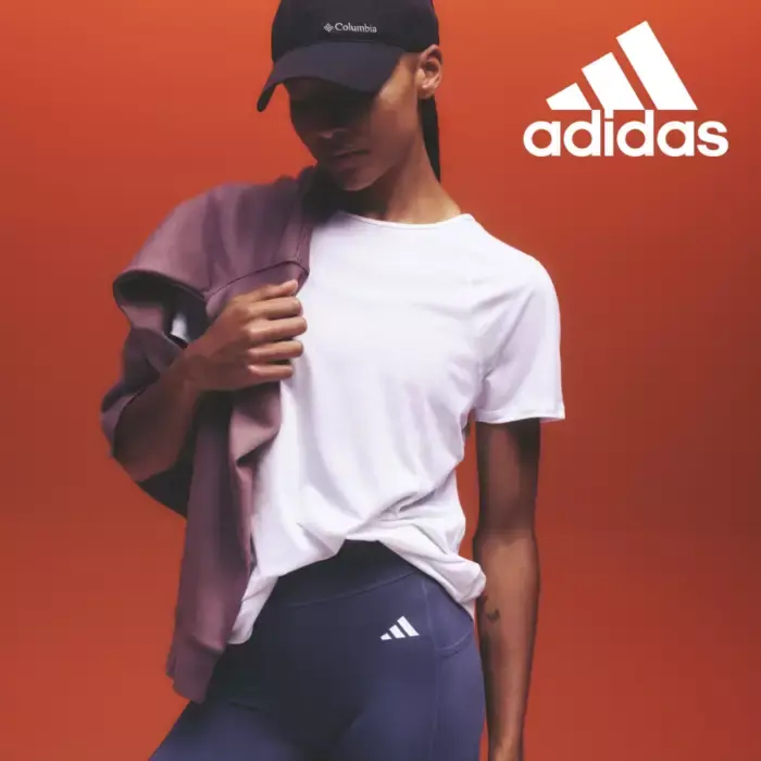 Woman wearing adidas sports leggings and white t-shirt. Shop adidas