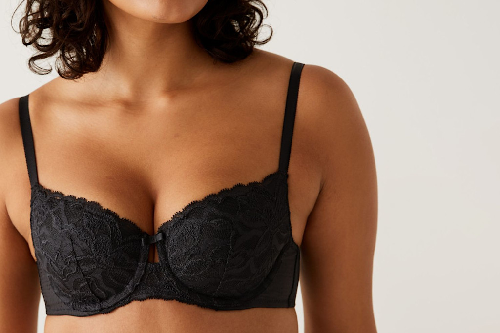 Woman wearing black bra. Shop bras