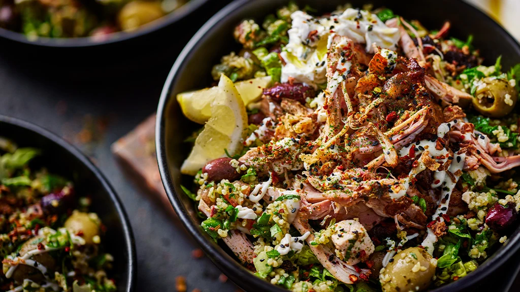 Chicken shawarma bowl with slices of lemon