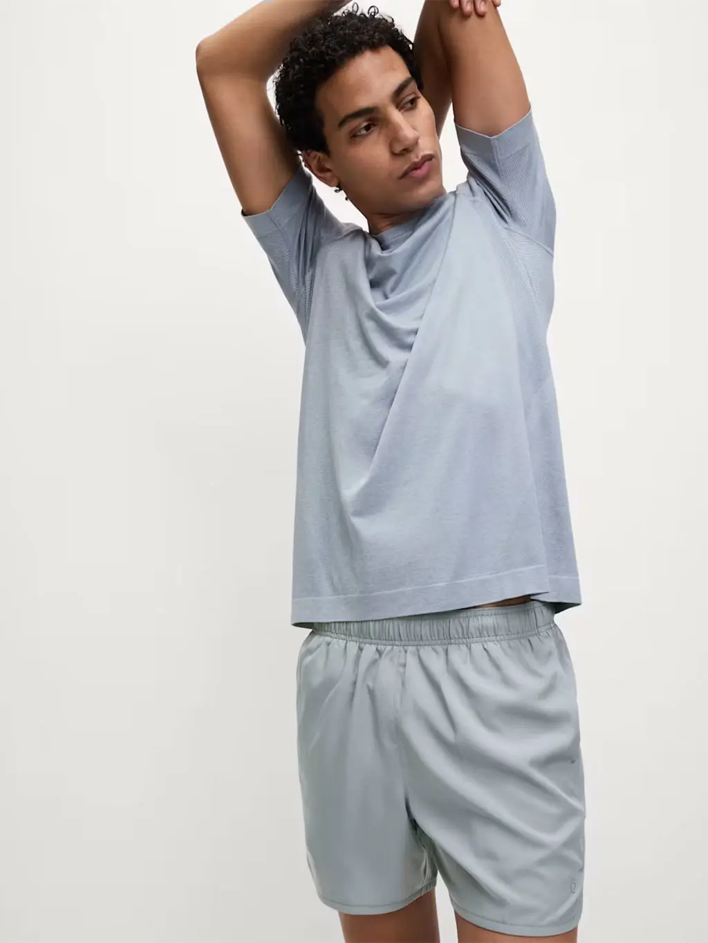 Man wearing a grey sports top and shorts