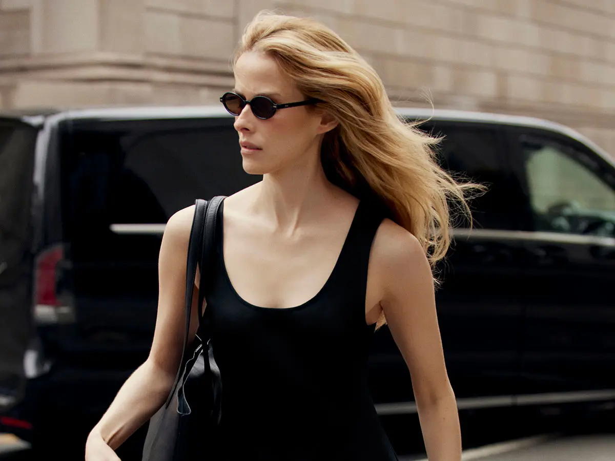 Woman wearing black dress and black sunglasses 