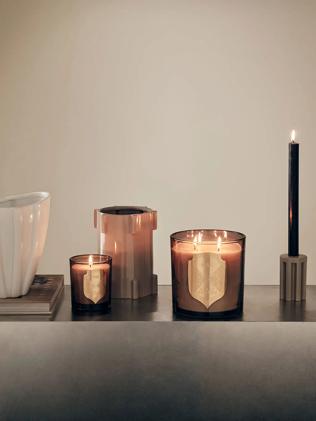Group of candles and candleholders from the M&S Kelly Hoppen range.