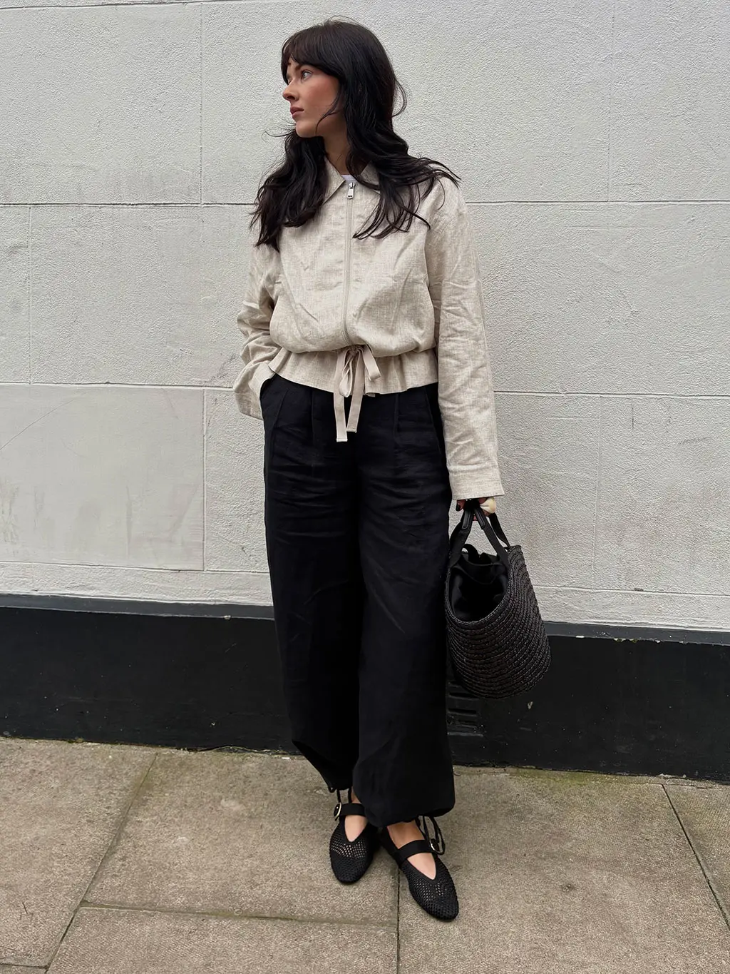Woman wearing linen jacket and black trousers