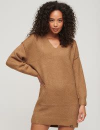 Woman wearing brown knitted dress. Shop 30% off selected Superdry
