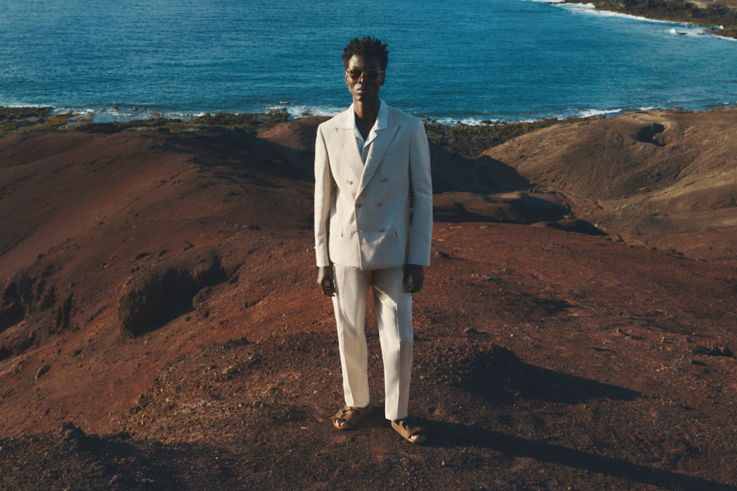 Man wearing white blazer.