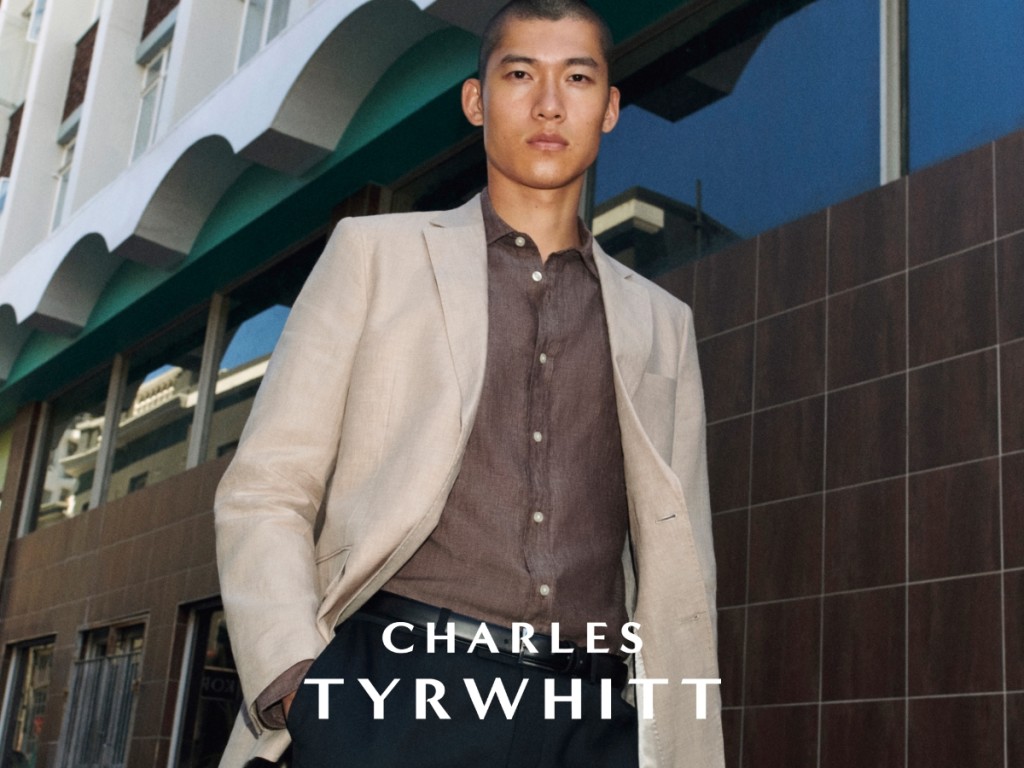 Man wearing cream blazer over a brown shirt. Shop Charles Tyrwhitt