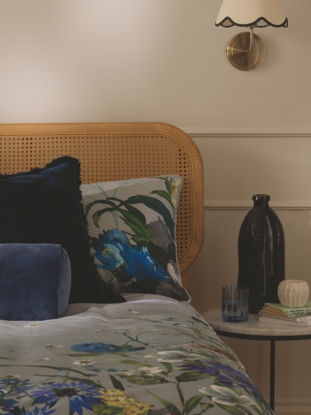 Bed made with a blue floral duvet set and finished with blue cushions. Shop The Collection trend