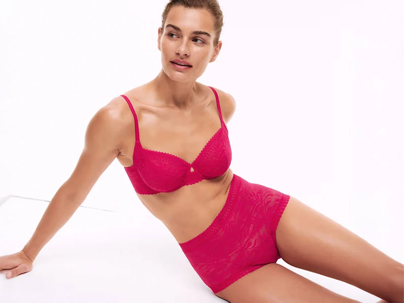 Woman wearing hot pink bra and matching period pants