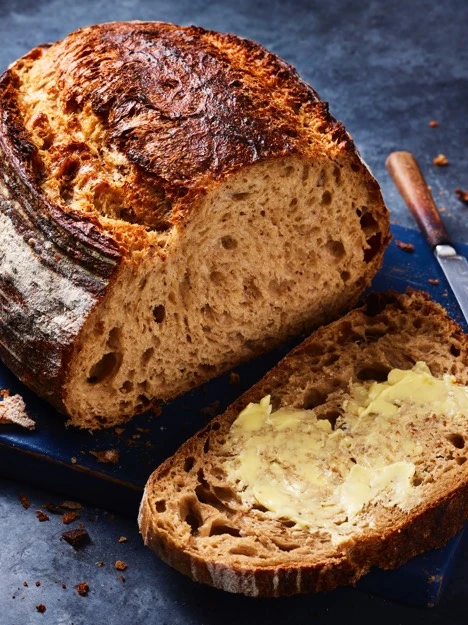 Sliced loaf of bread with butter