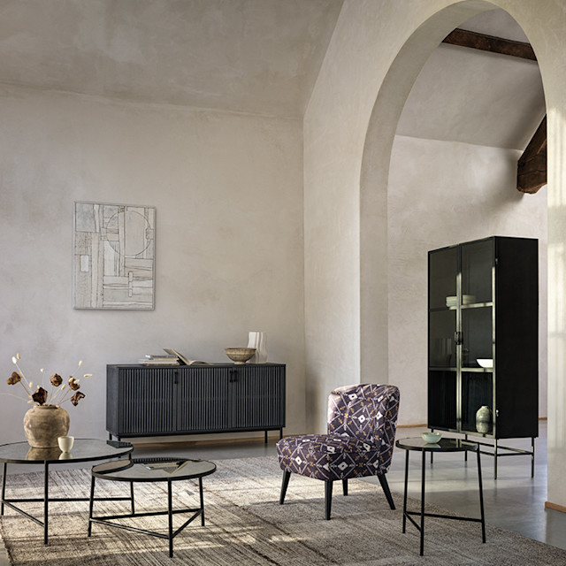 Living room with accent chair, tables, shelving and furniture. Shop sofas