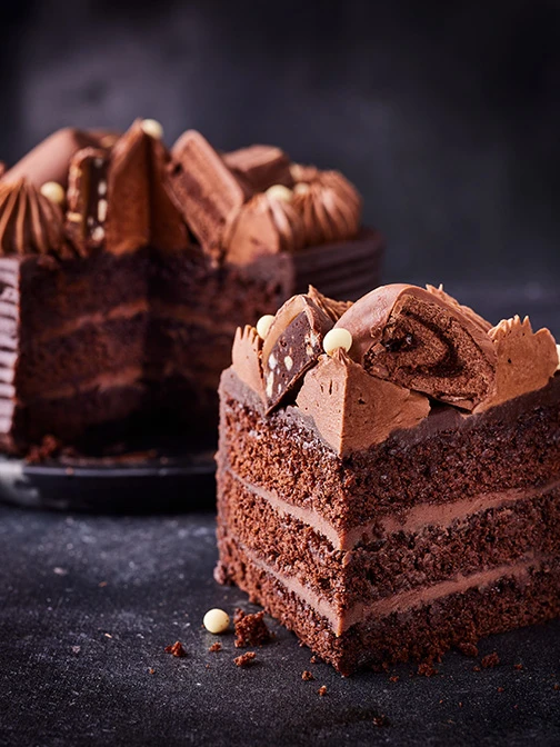 Chocolate celebration cake against a black background