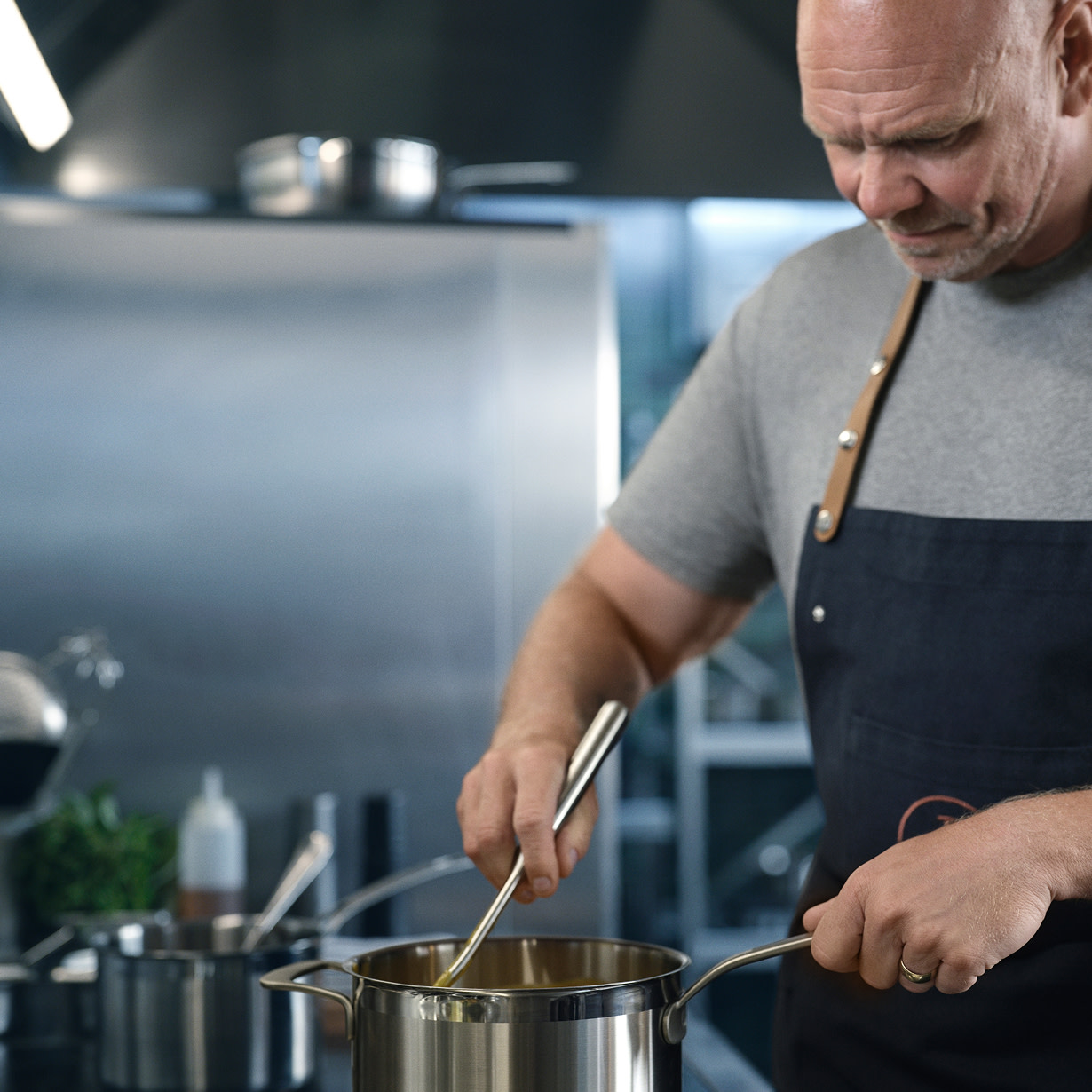 Tom Kerridge with a stainless steel pan
