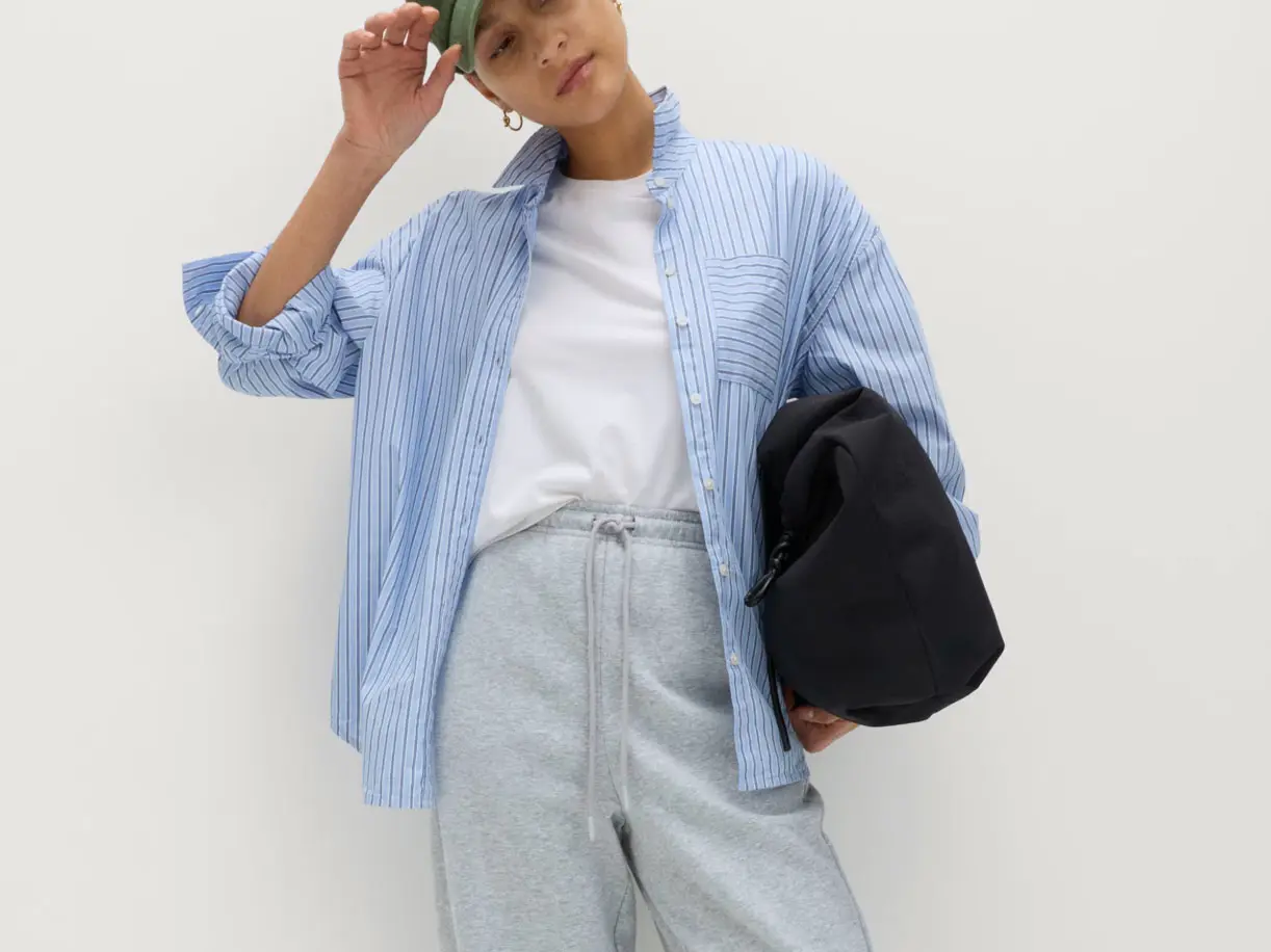 Woman wearing a blue shirt and grey joggers