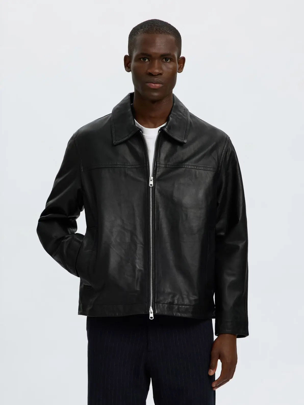 Man wearing black leather zip-up jacket 