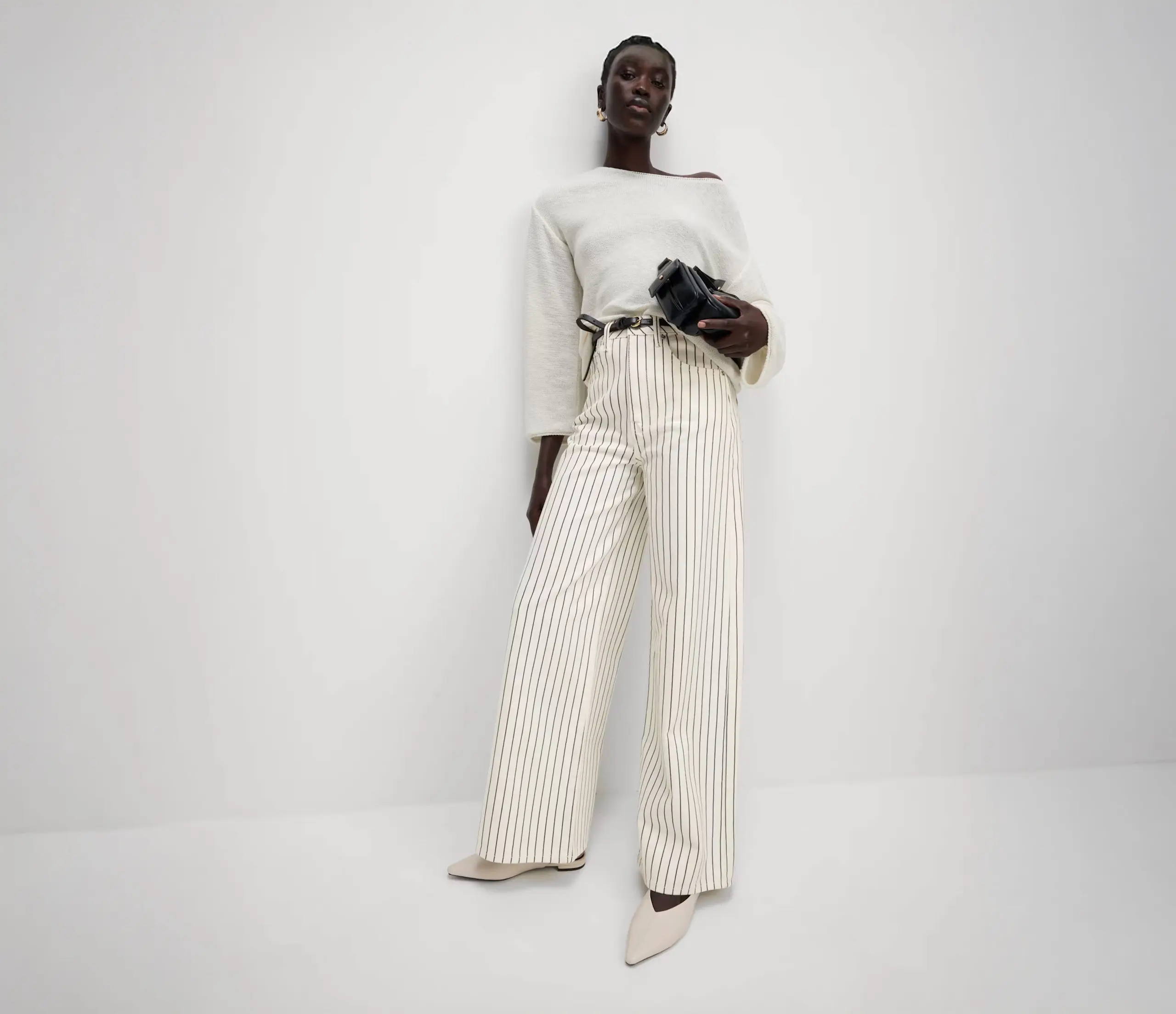 Woman wearing cream striped wide-leg trousers and a cream top